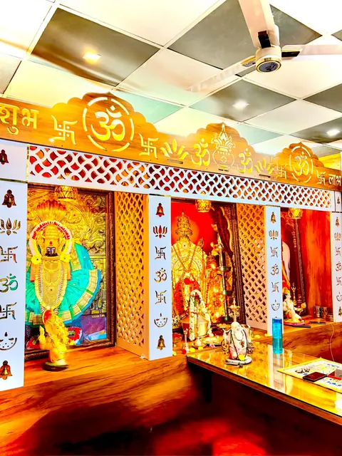 Pooja room with carved Om arch