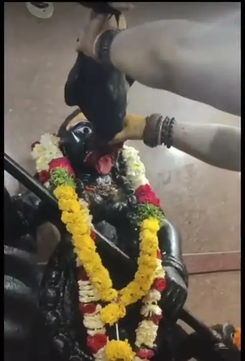 Abhishekam of the black stone Kali idol